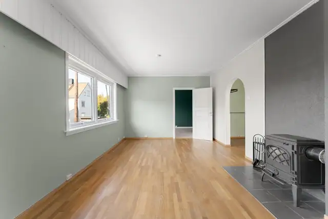 Stuen har flere store vindusflater som slipper inn godt med naturlig lys, samt vedovn som gir en lun og hyggelig atmosfære.