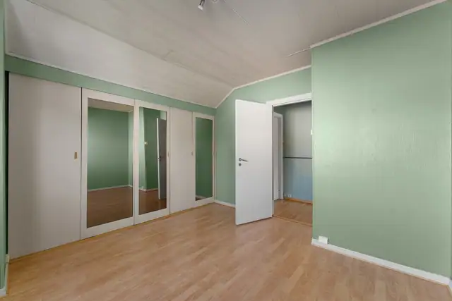 Soverommet har en praktisk og stor skyvedørsgarderobe